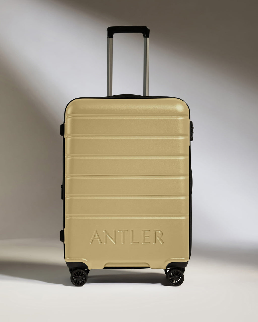 Medium Suitcase in Dark Sand - Logo
