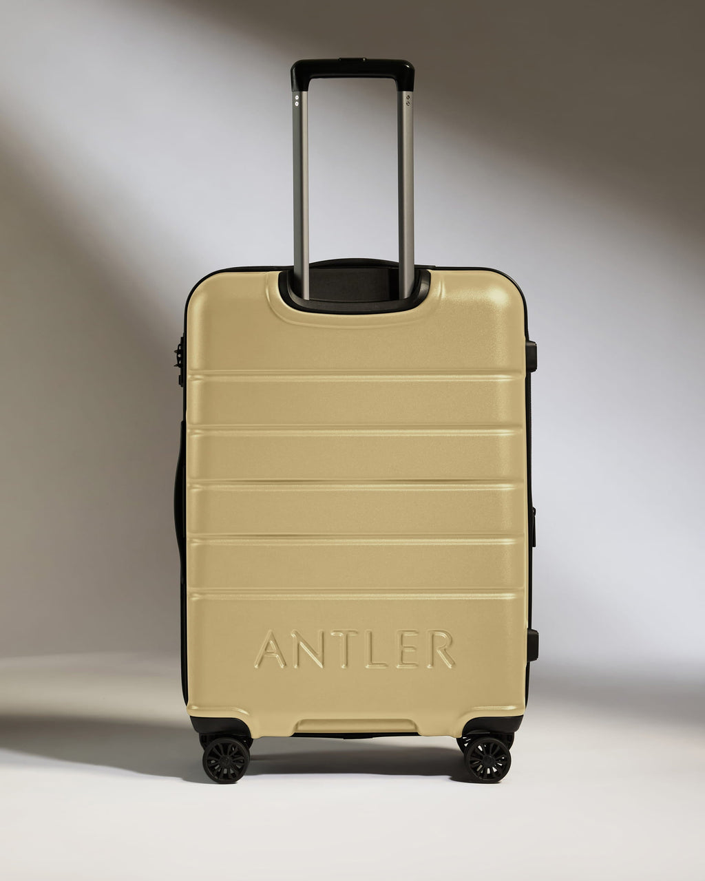Medium Suitcase in Dark Sand - Logo